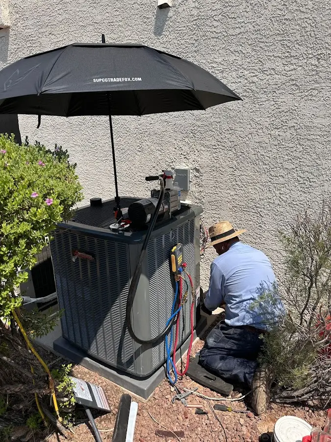 HVAC technician performing outdoor AC maintenance in Rockwall